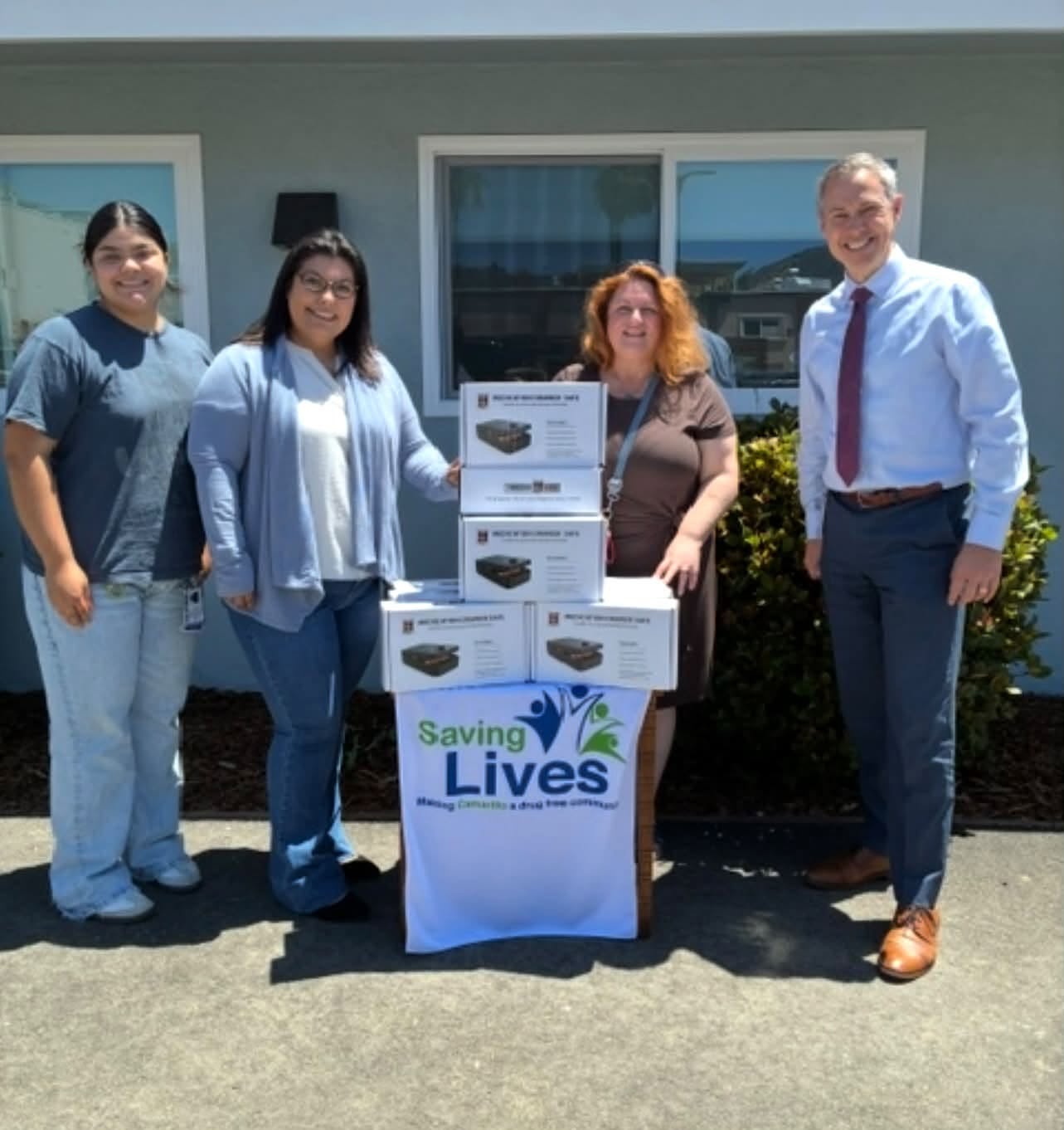 Coalition staff receiving a Saving Lives community donation