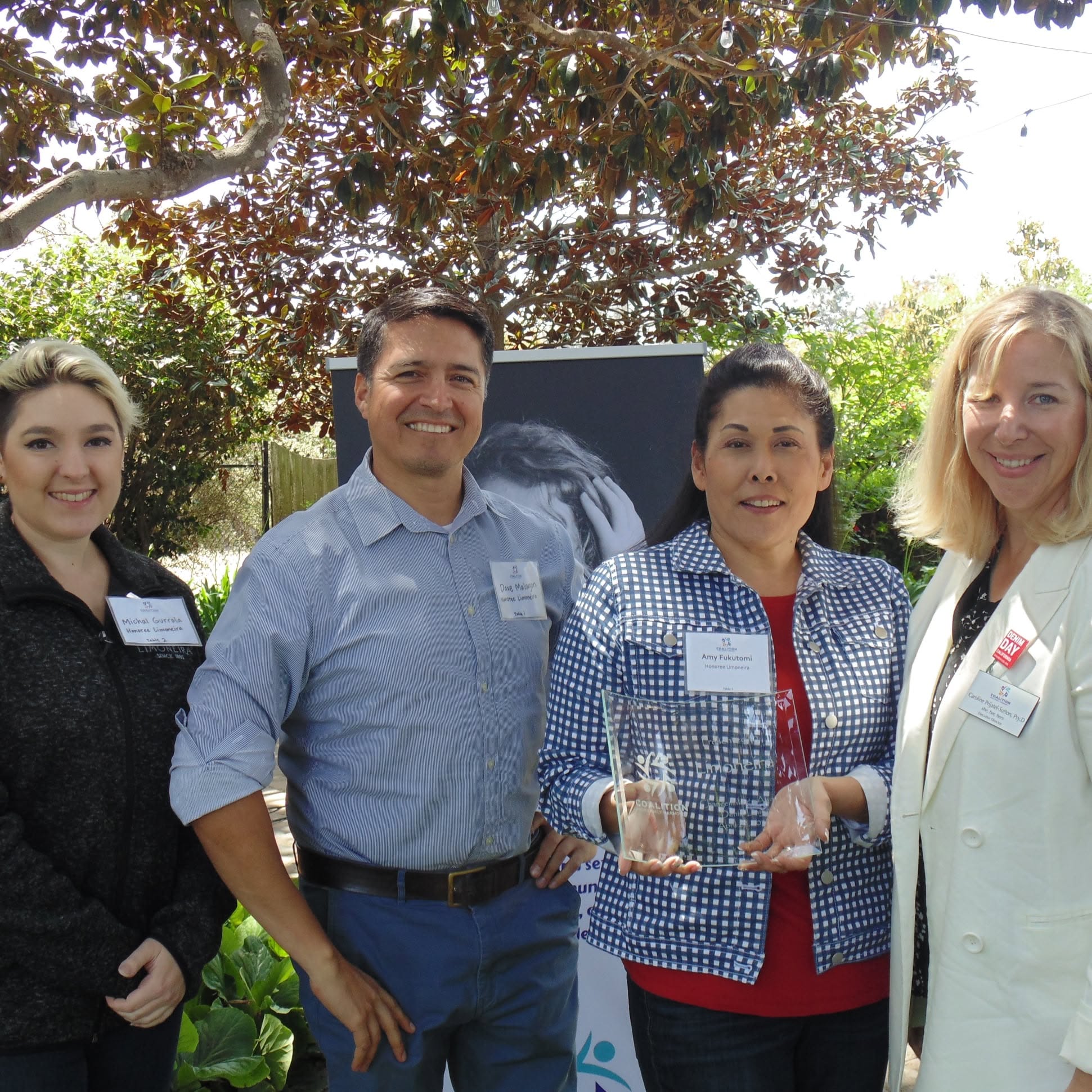 Coalition team members receiving a community service award outdoors